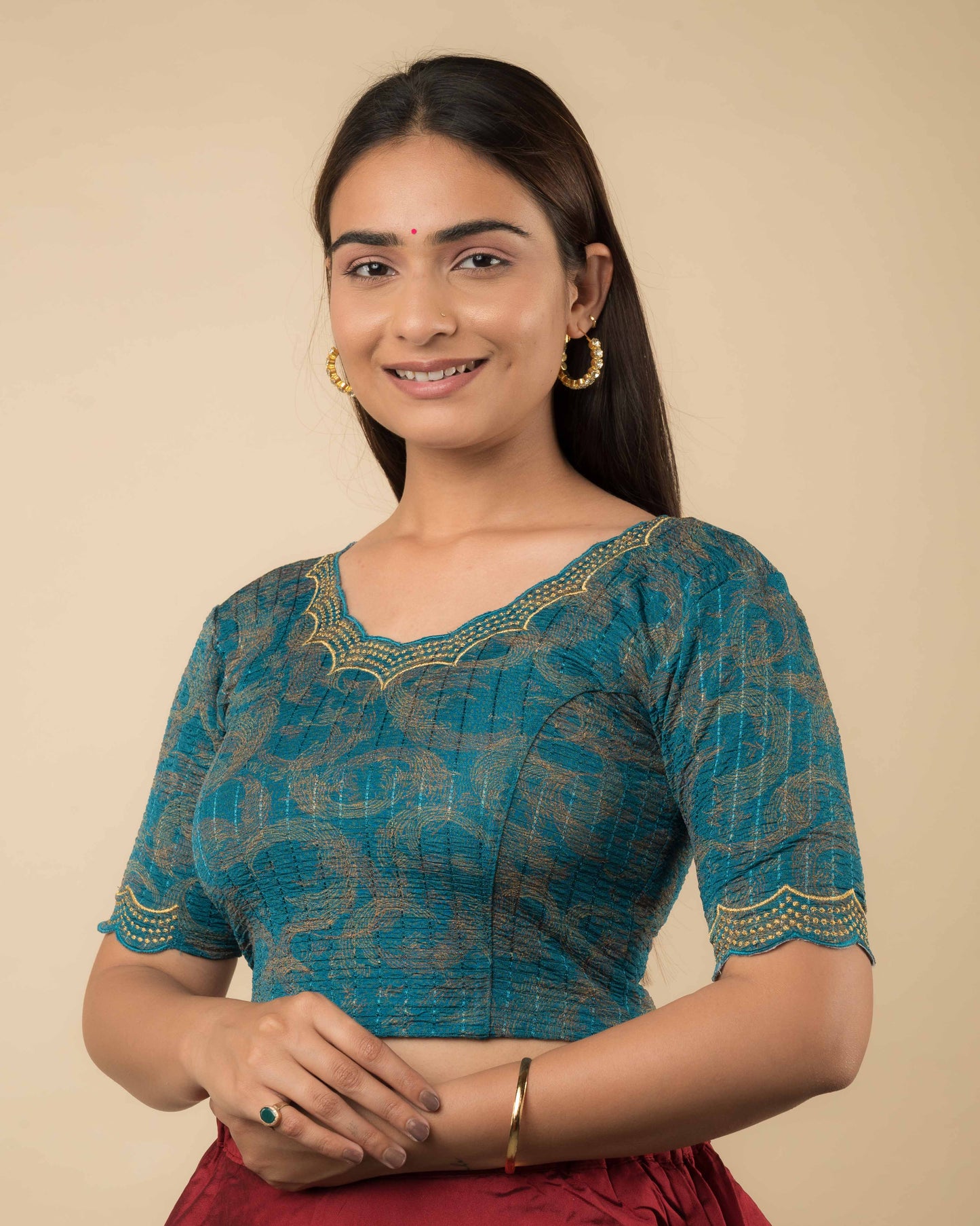 Side profile of the rama green-colored stretchable blouse highlighting the fit, sleeve length, and zari embroidery.