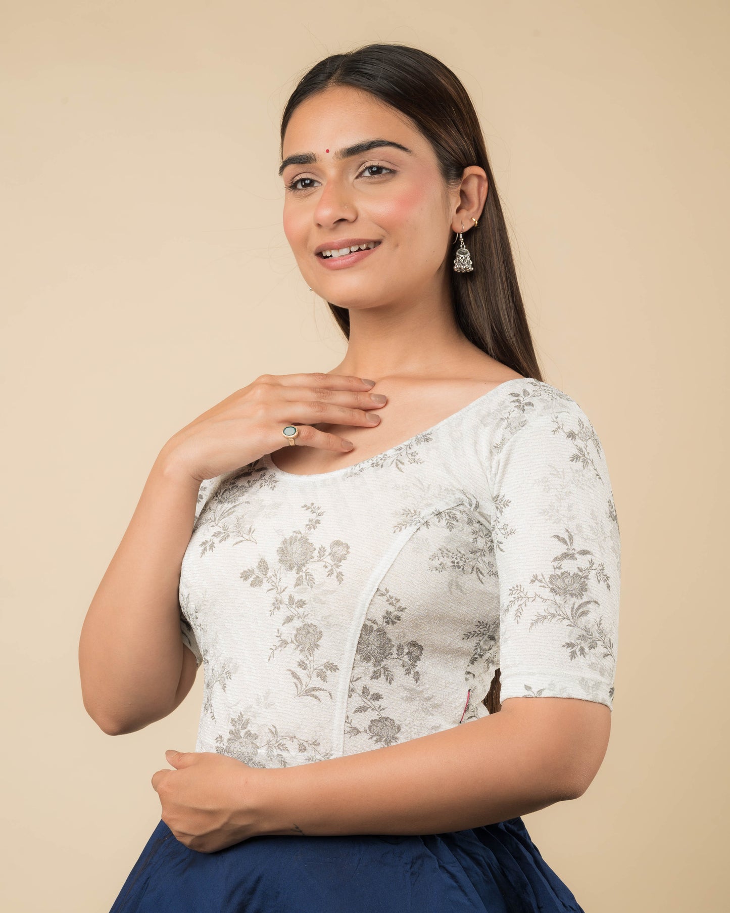 Side profile of the metallic floral stretchable blouse highlighting the fit and sleeve length.