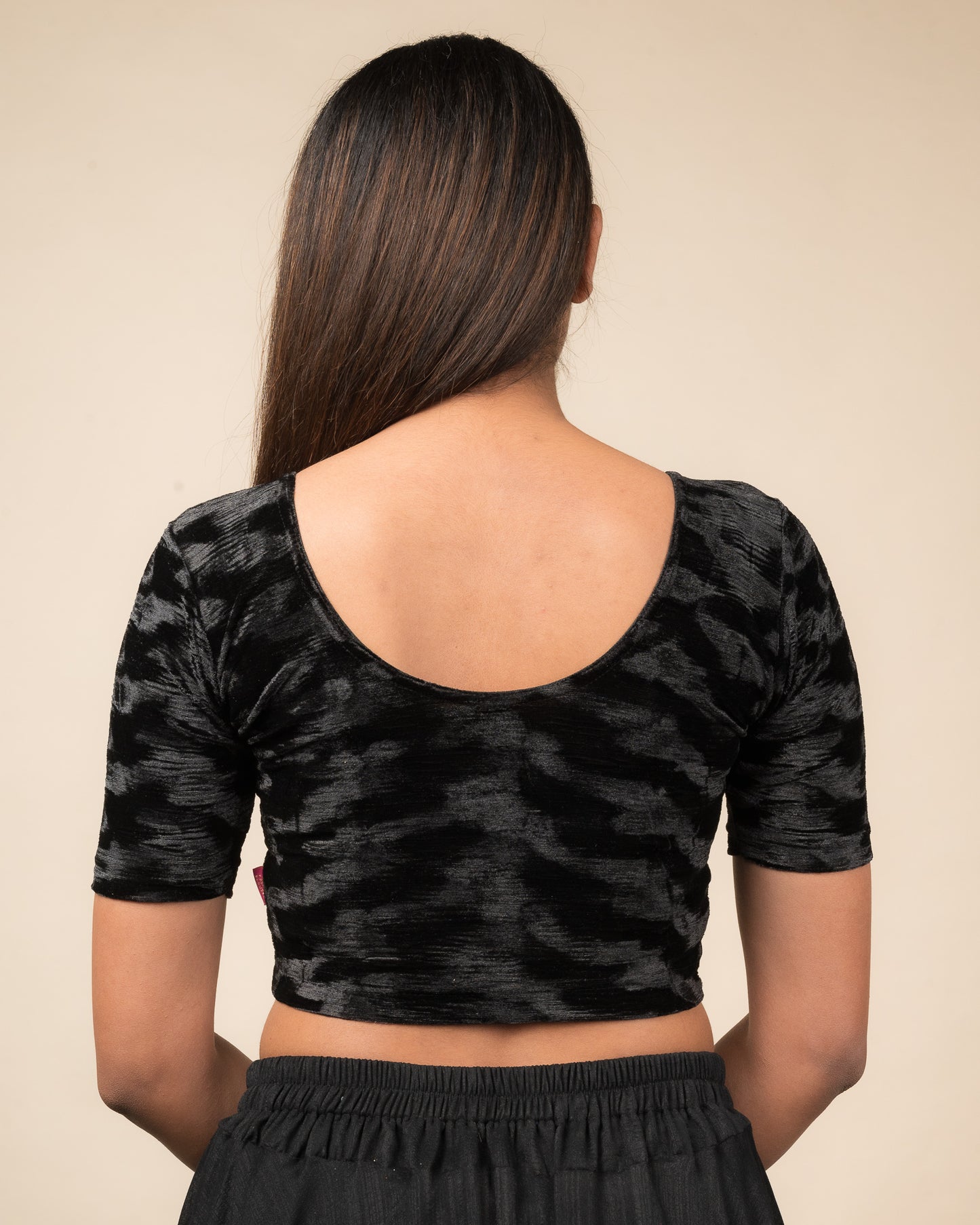 Rear view of the zari embellished velvet stretchable blouse showcasing the back design.