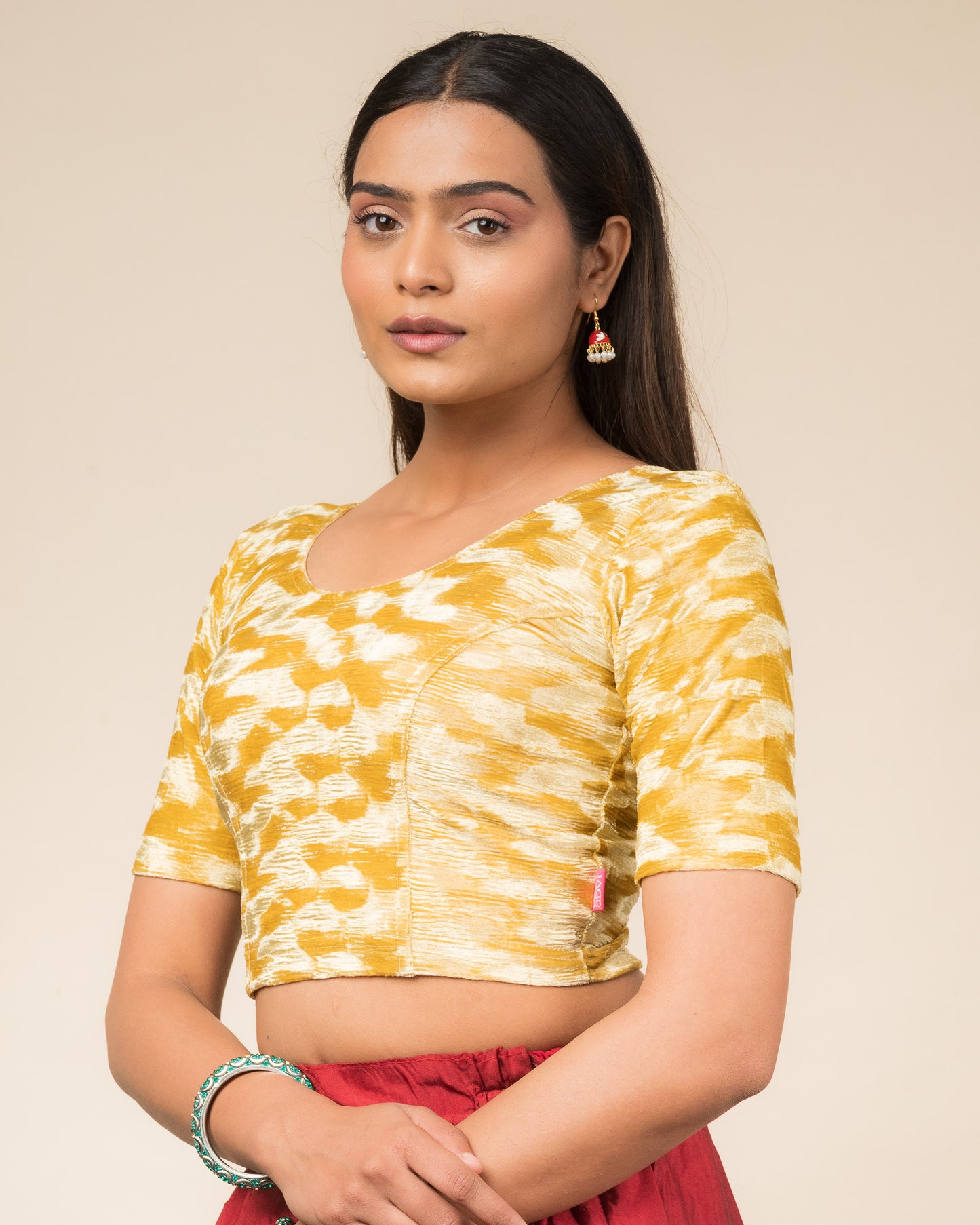 Side profile of the zari embellished velvet stretchable blouse highlighting the fit and sleeve length.
