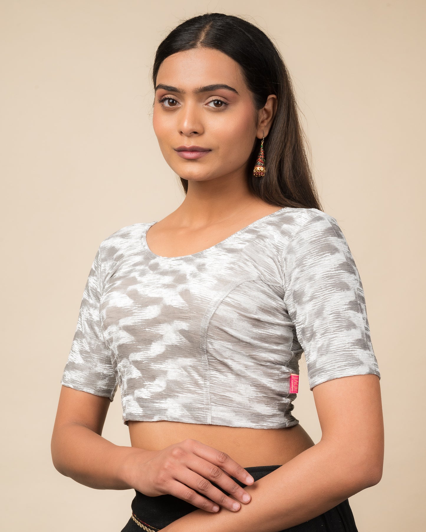 Side profile of the zari embellished velvet stretchable blouse highlighting the fit and sleeve length.