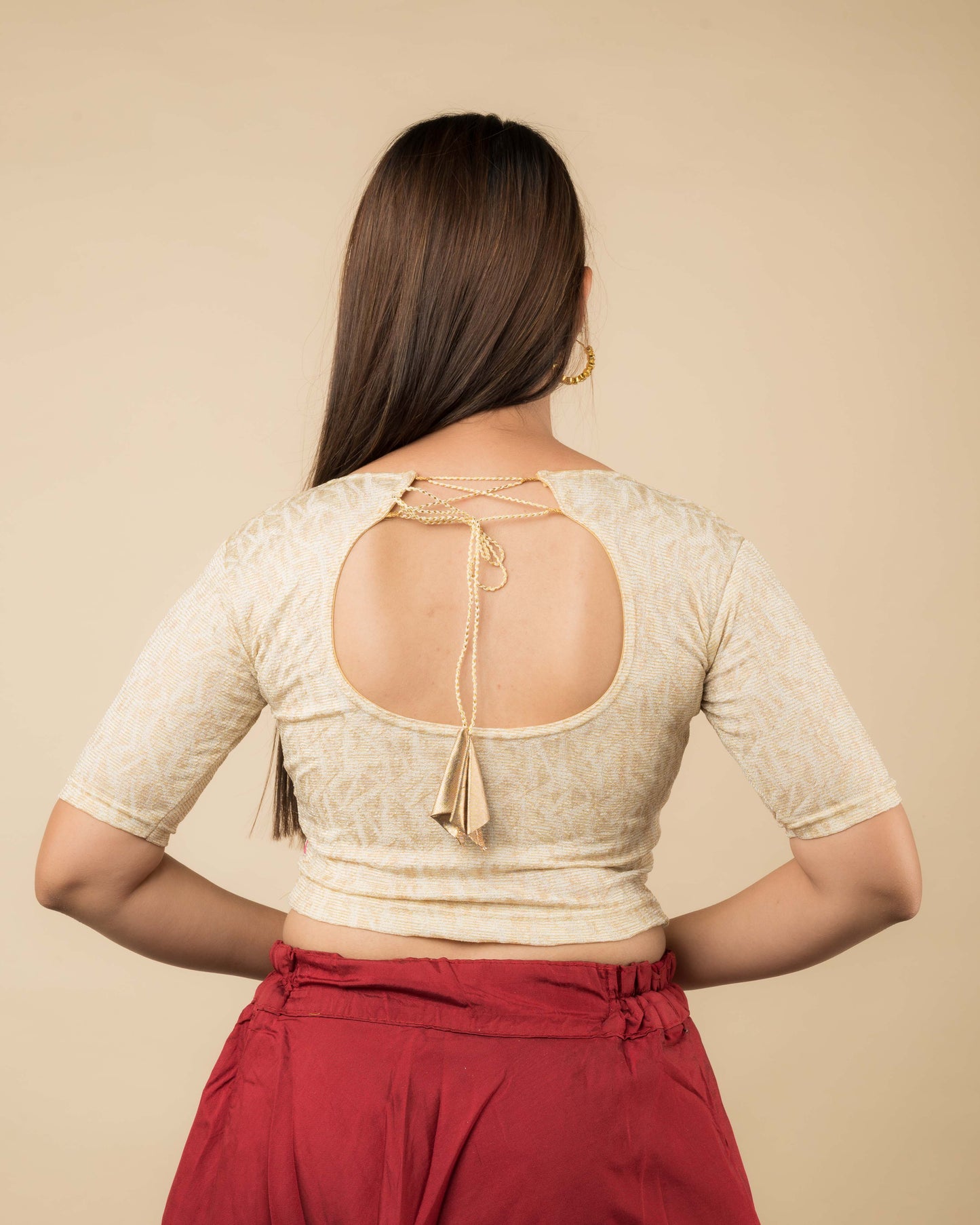 Rear view of the jacquard stretchable blouse showcasing the dori tie-up with tassels.