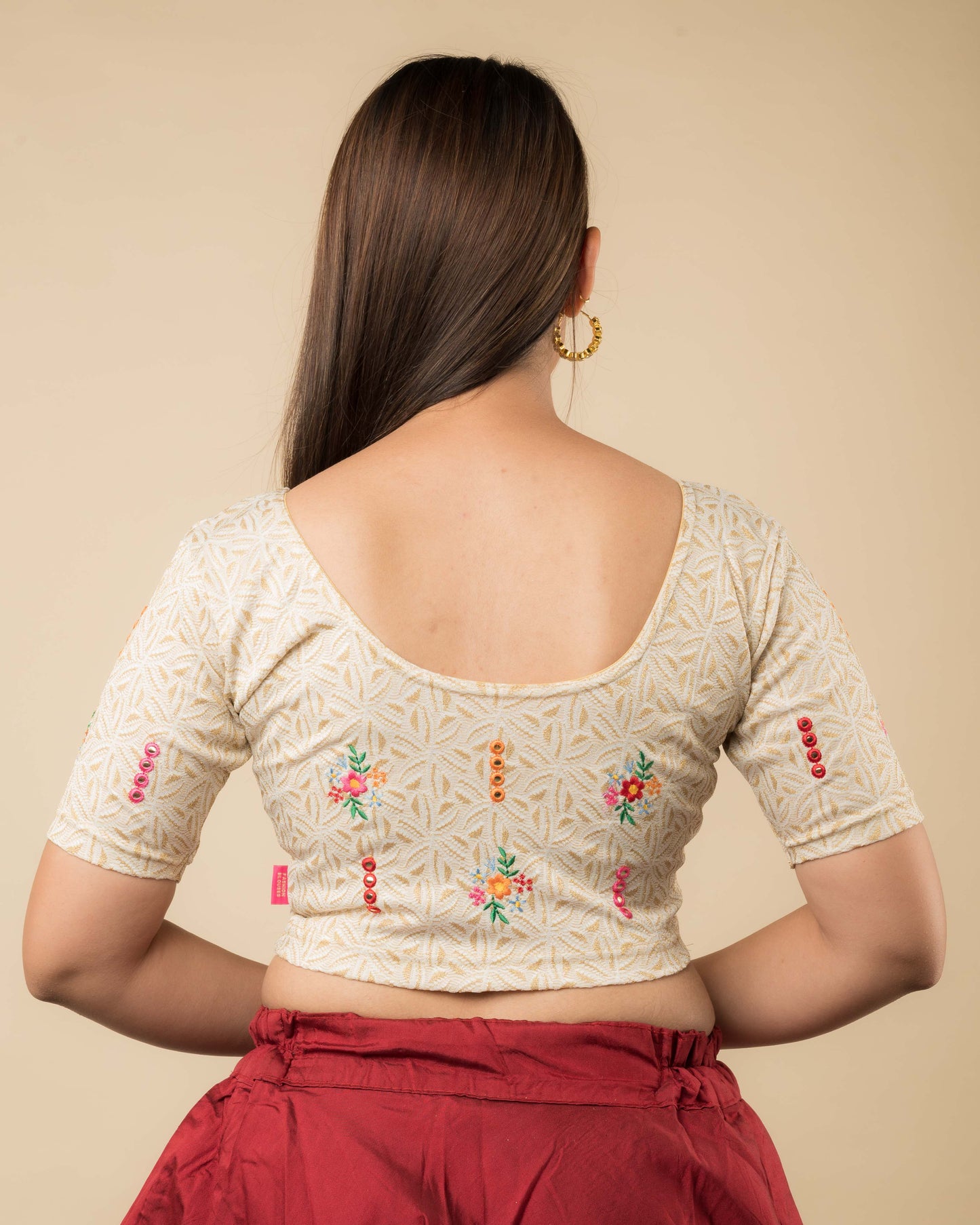 Rear view of the mirror embellished knitted stretchable blouse showcasing the back design.