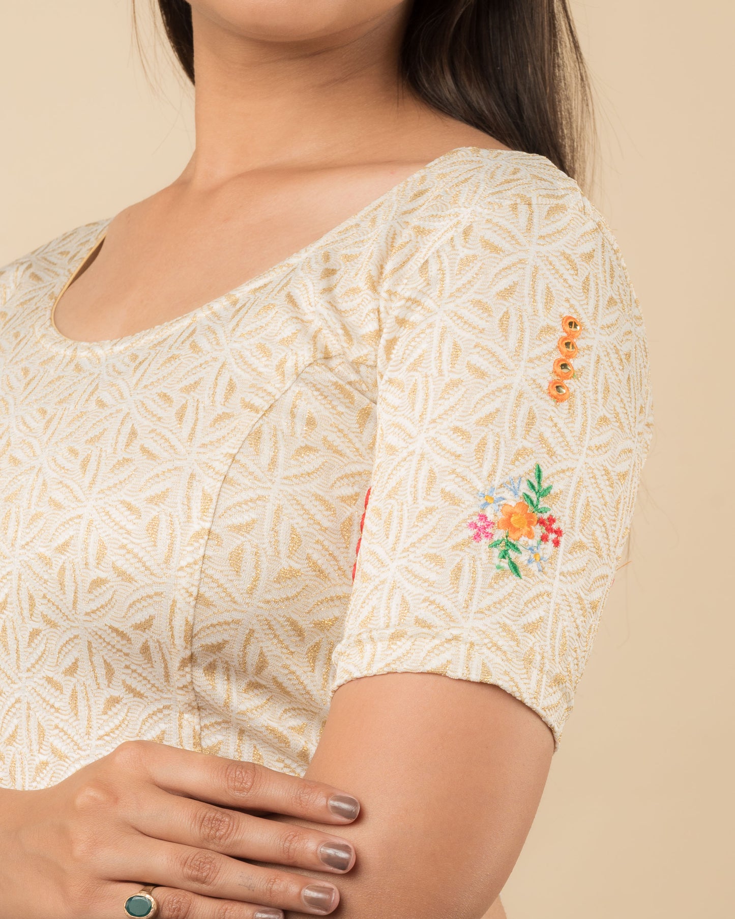 Close-up of the jacquard fabric detailing the mirror embroidery and stretchability of the readymade blouse.