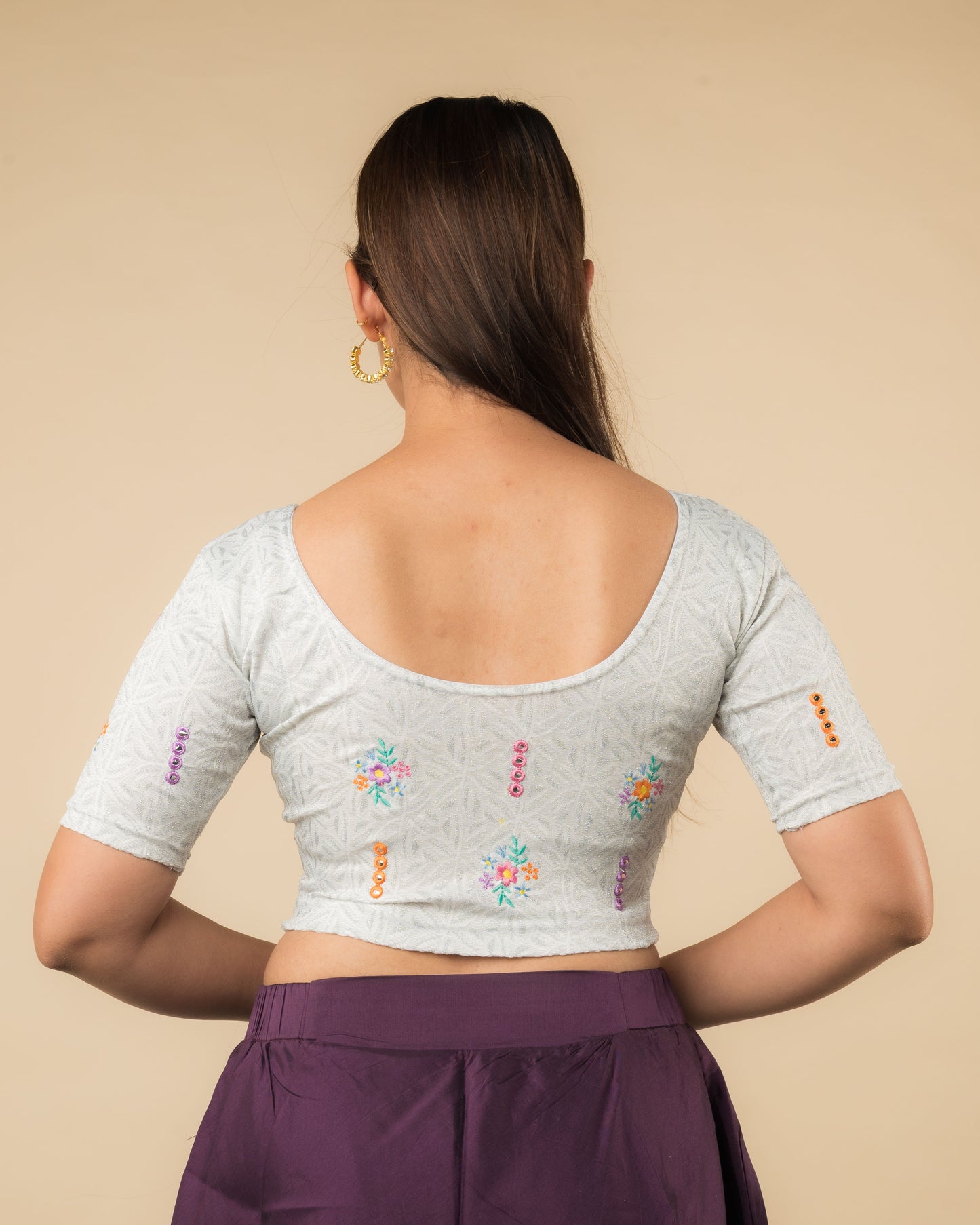 Rear view of the mirror embellished knitted stretchable blouse showcasing the back design.