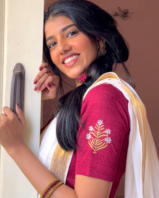 Model wearing a buti embroidered stretchable readymade blouse with elbow sleeves and round neckline.