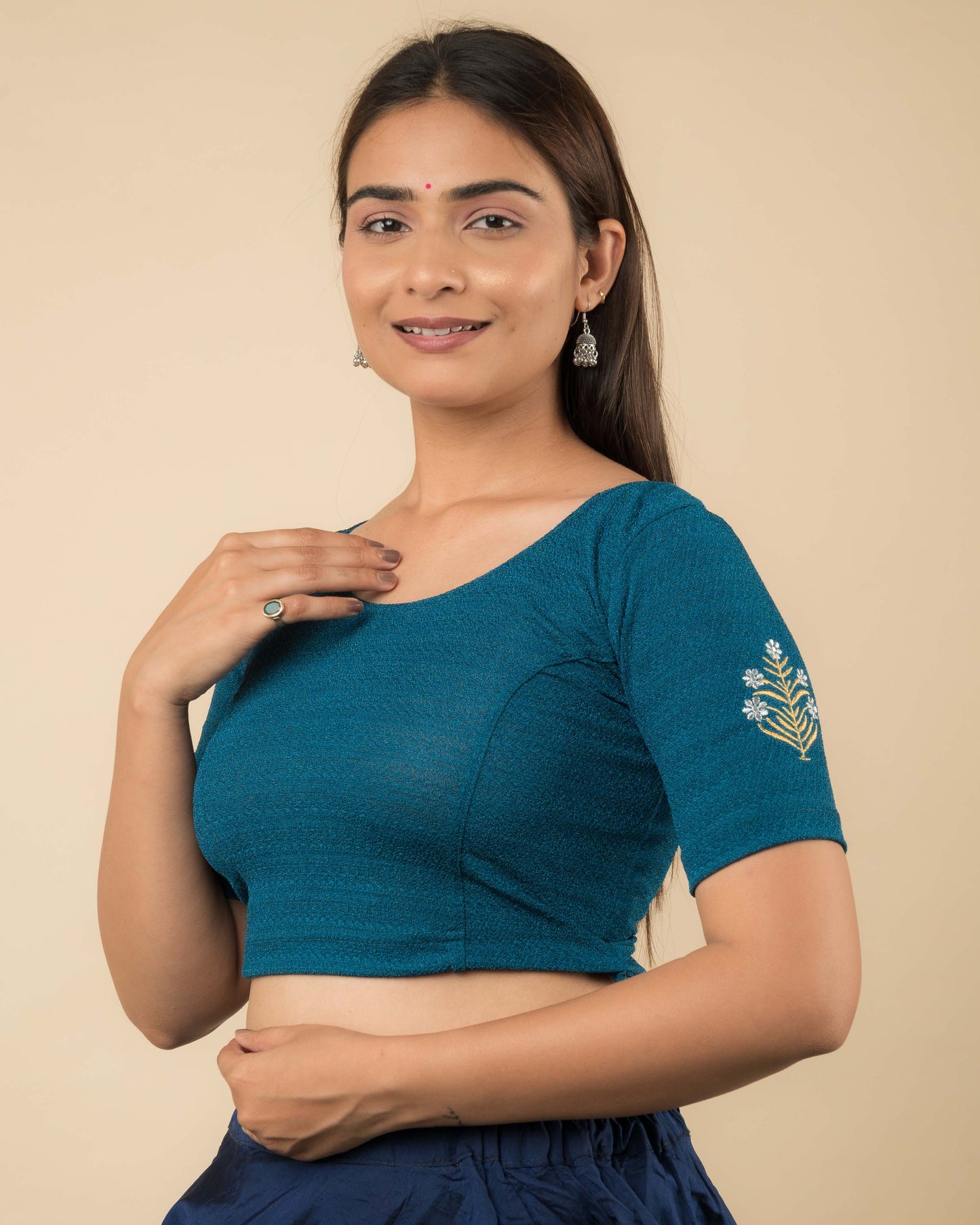 Side profile of the white buti embroidered stretchable blouse highlighting the fit and sleeve length.
