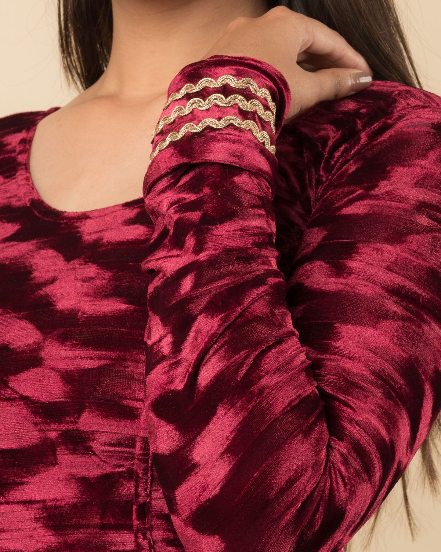Close-up of the velvet fabric detailing the zari embroidery and stretchability of the readymade blouse.