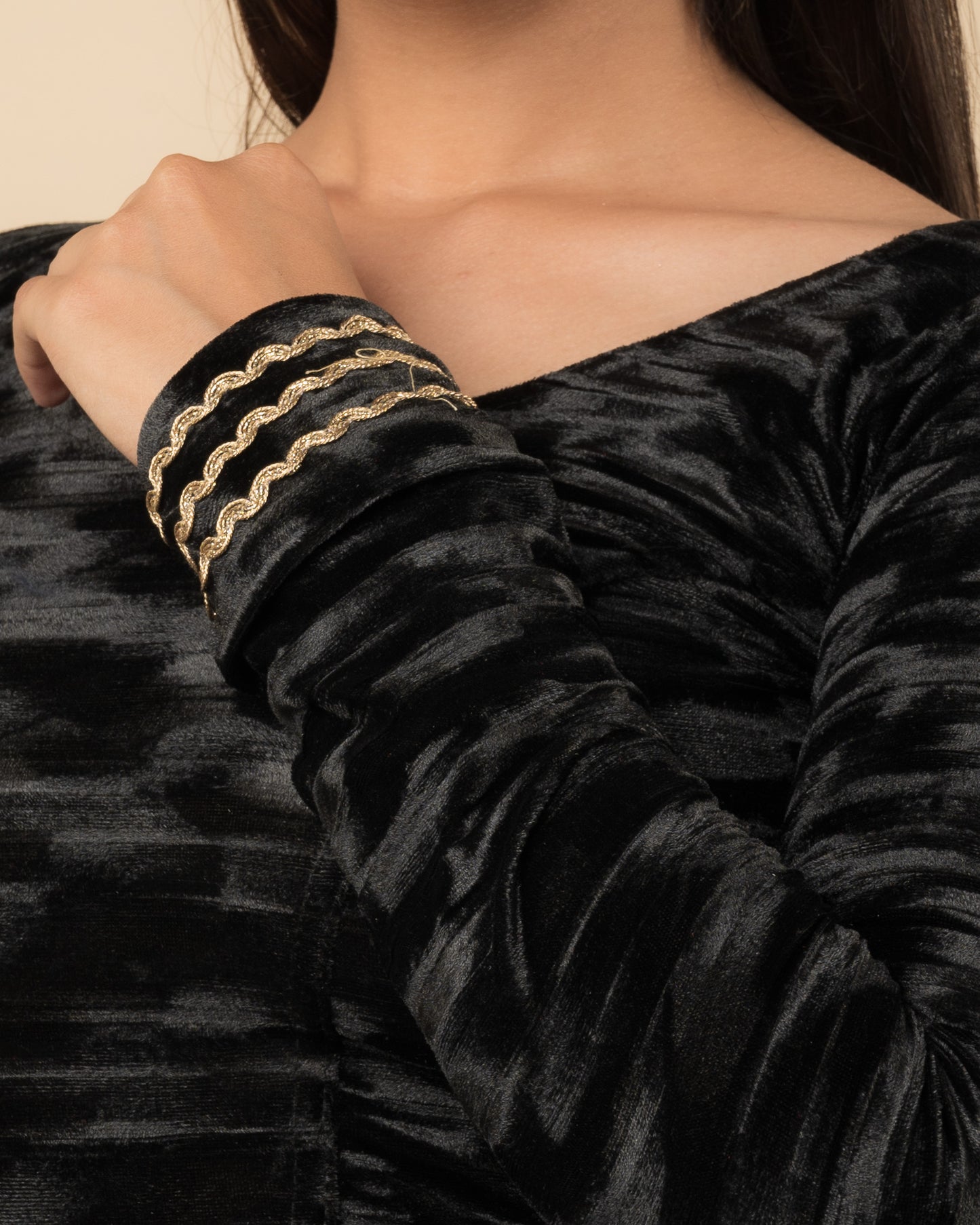 Close-up of the velvet fabric detailing the zari embroidery and stretchability of the readymade blouse.