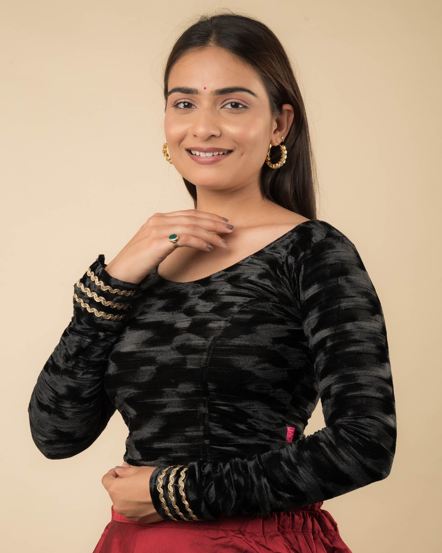 Side profile of the black velvet stretchable blouse highlighting the fit and sleeve length.