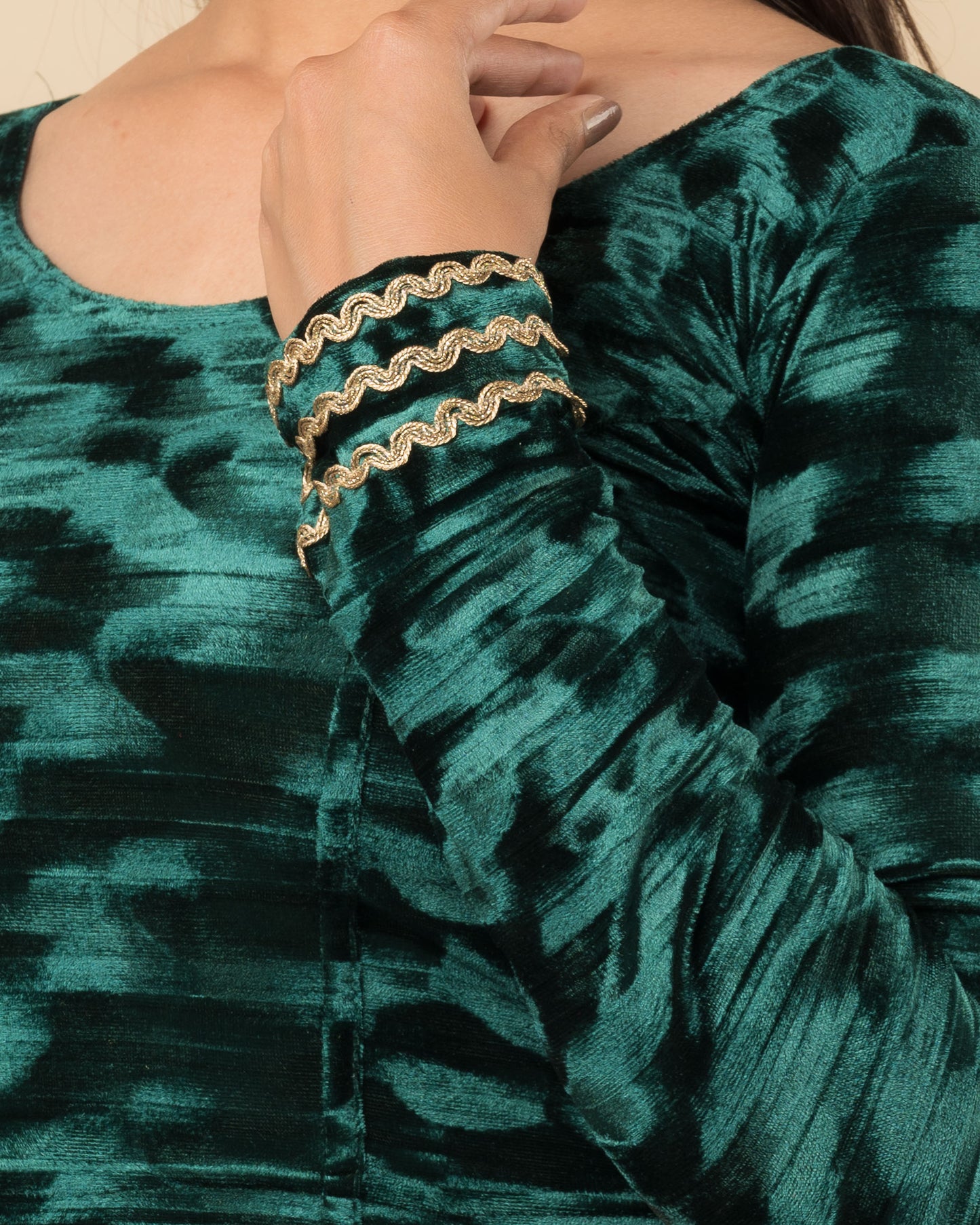 Close-up of the velvet fabric detailing the zari embroidery and stretchability of the readymade blouse.