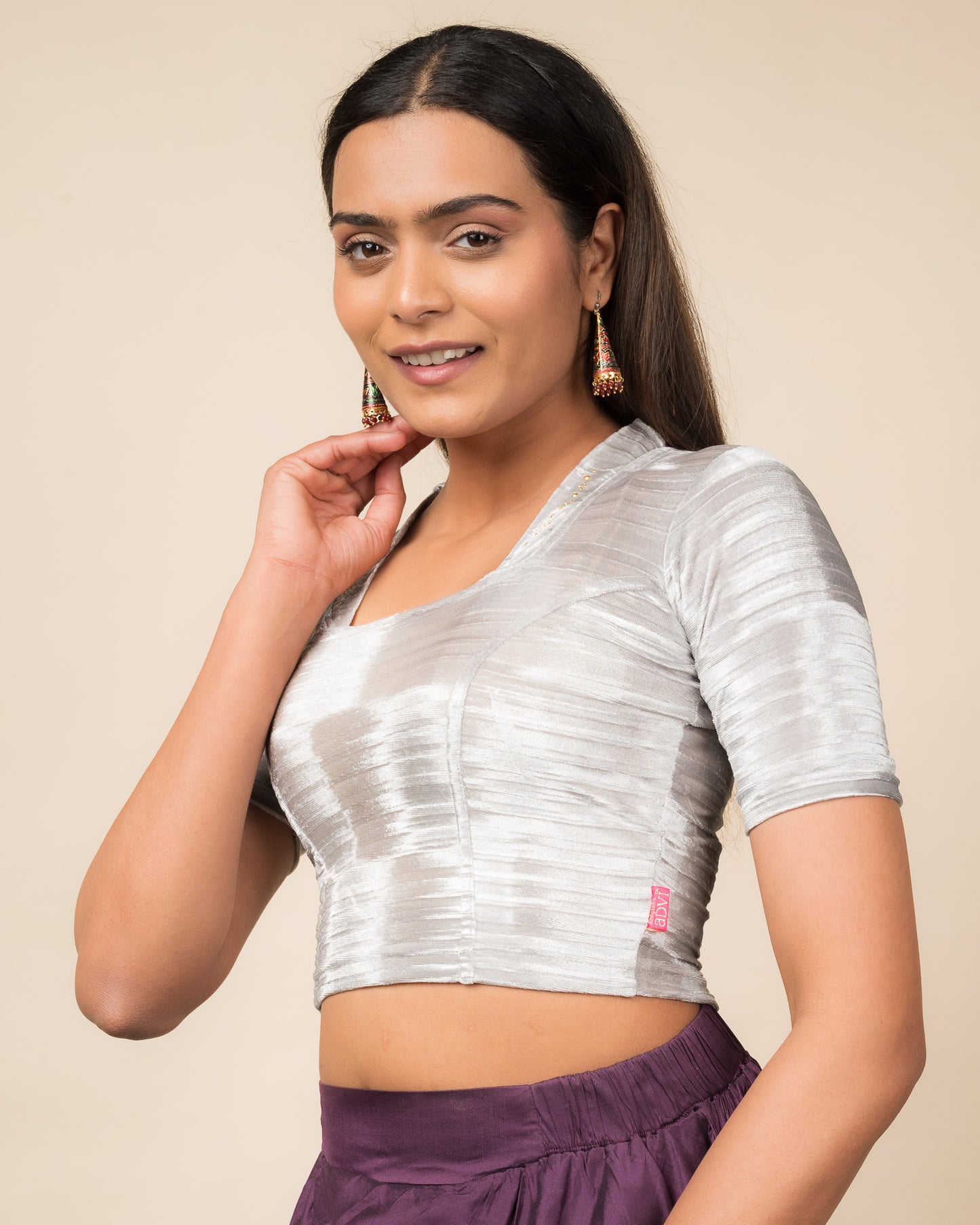 Side profile of the gray velvet stretchable blouse highlighting the fit and sleeve length.