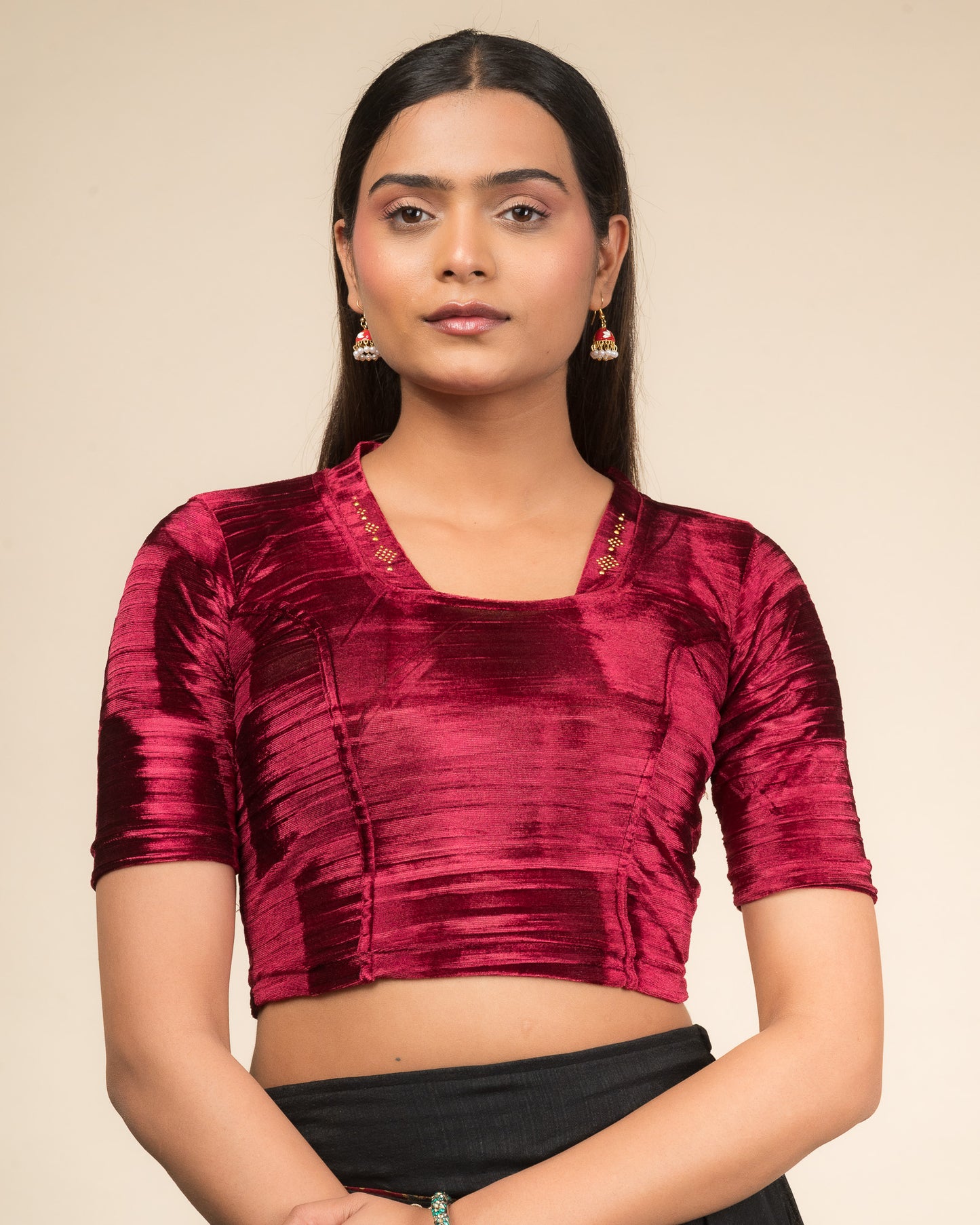 Model wearing a velvet stretchable readymade blouse with elbow sleeves and square neckline adorned with a diamond collar.