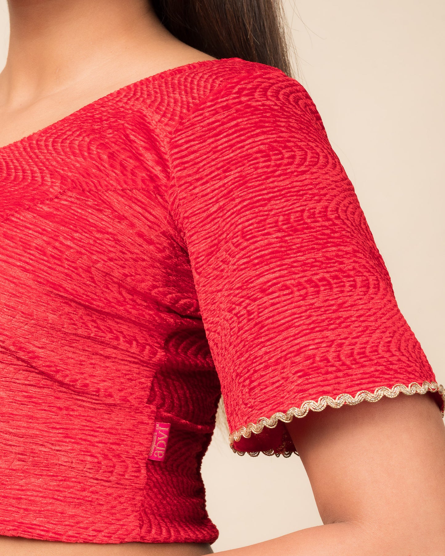 Close-up of the velvet fabric detailing the lace embroidery and stretchability of the readymade blouse.