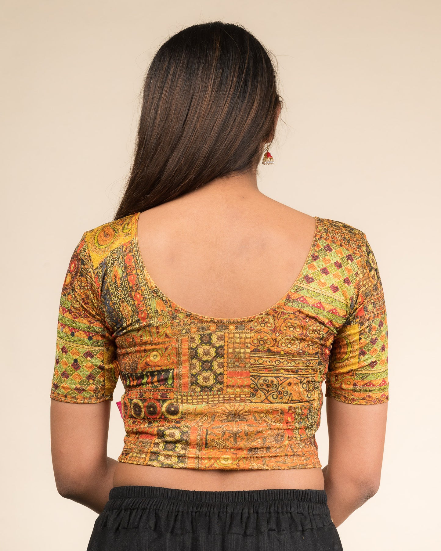 Rear view showcasing the blouse’s back design.