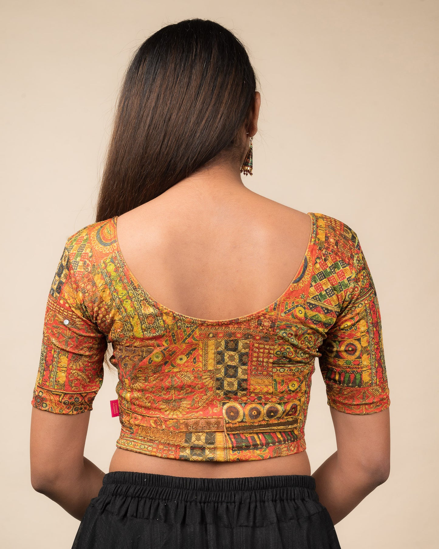 Rear view showcasing the blouse’s back design.