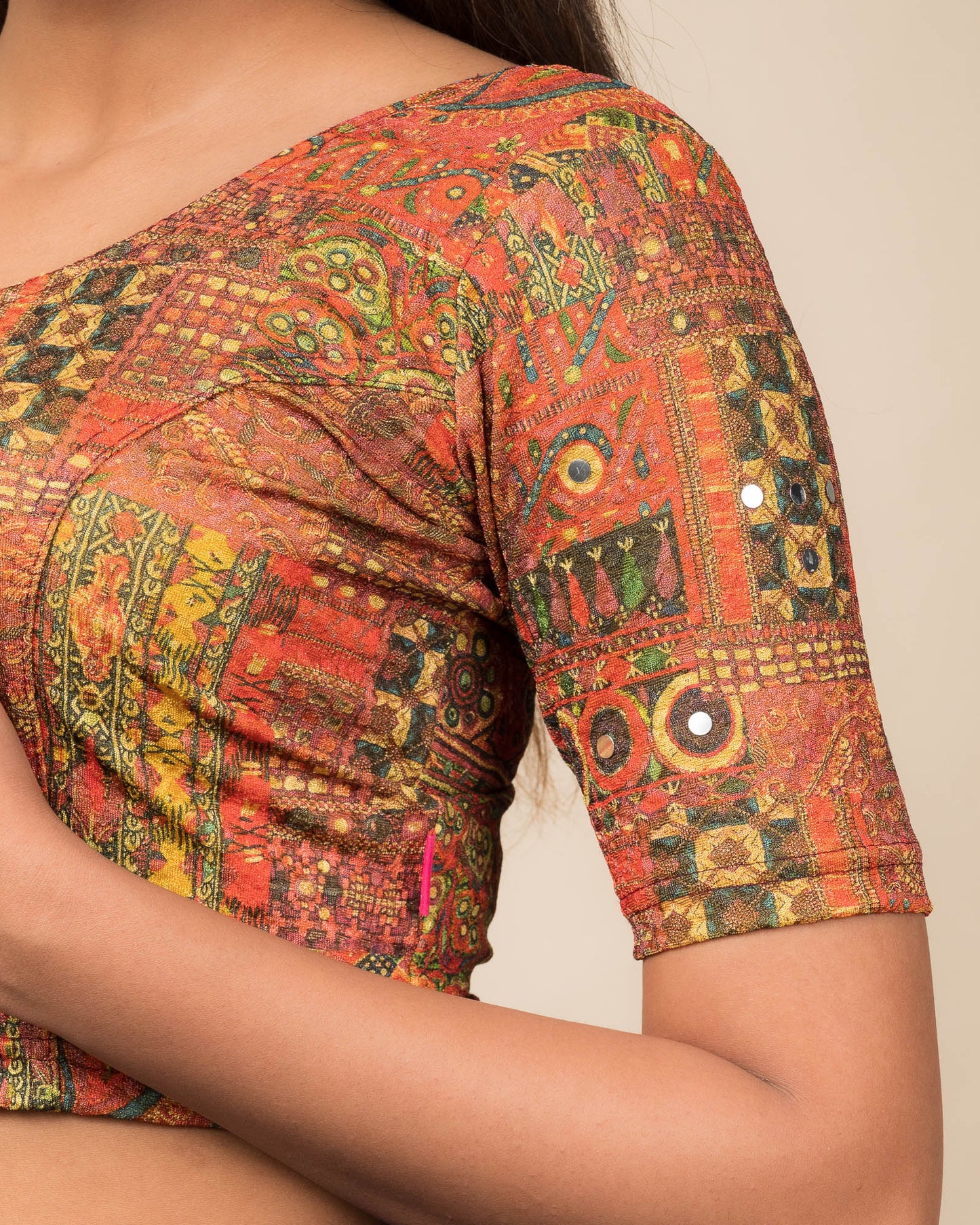 Close-up of the jacquard knit fabric with mirror and printed detailing.