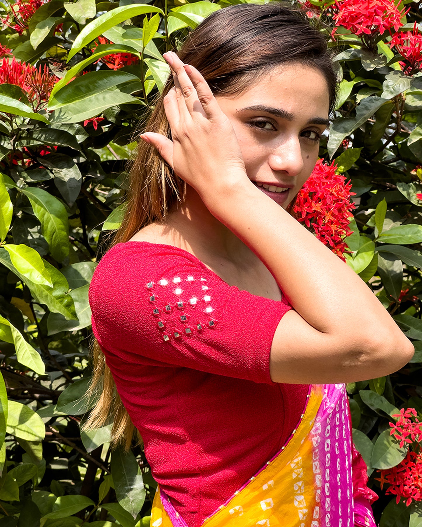 Model wearing a stretchable blouse with elbow-length sleeves and round neckline featuring mirror-embroidered butis.