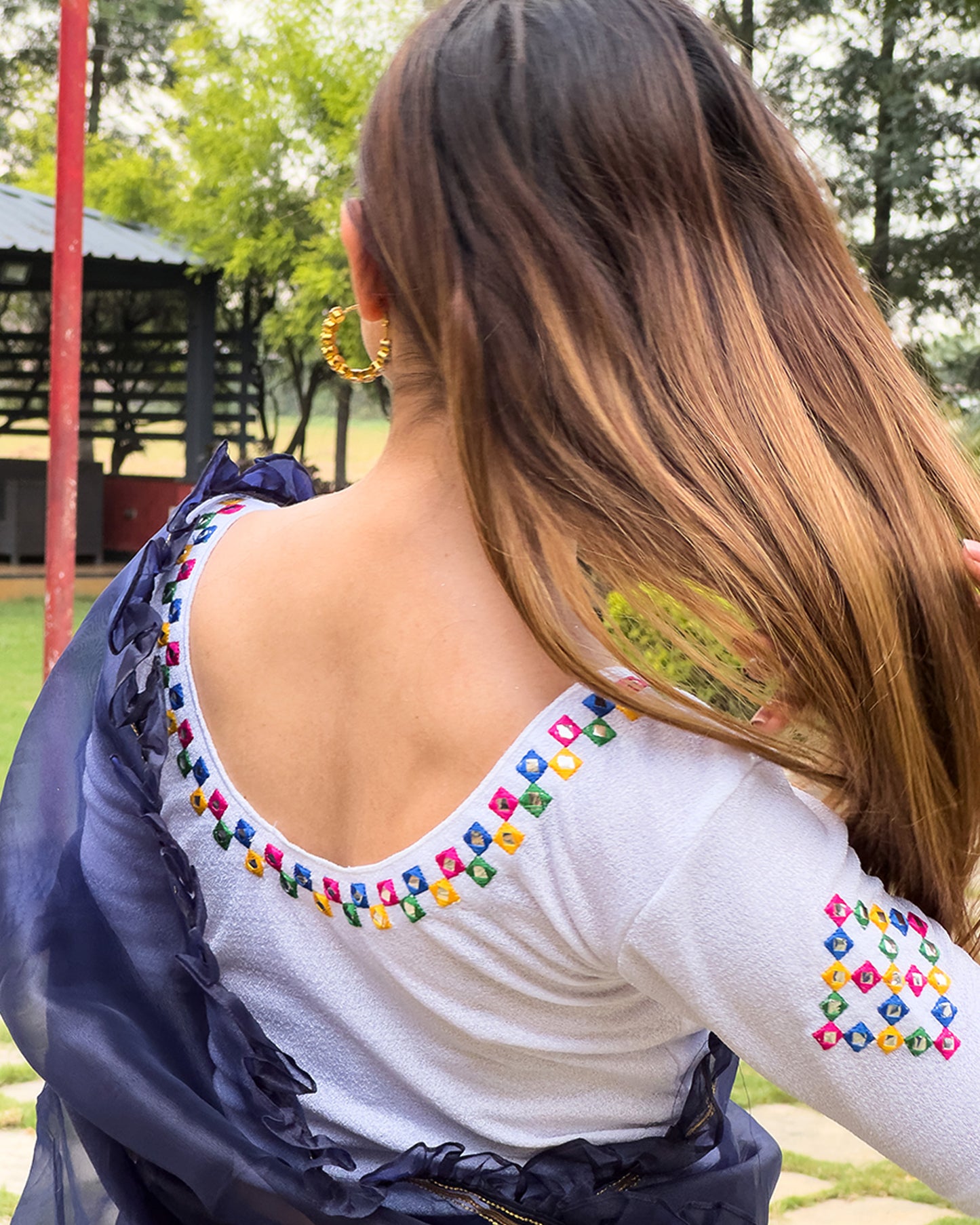 Rear view showcasing the embroidered details and back fit.