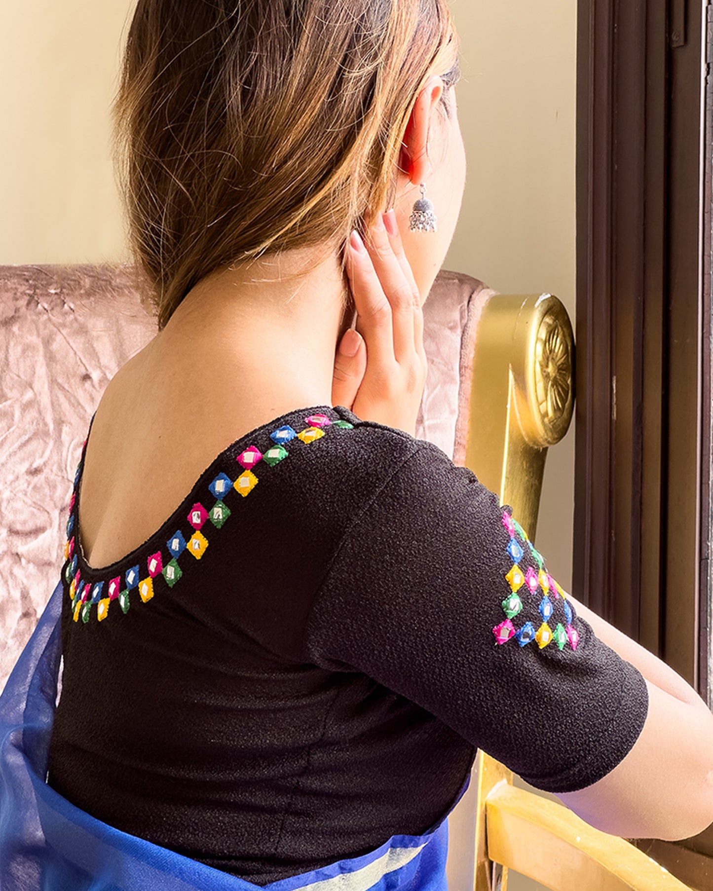 Close-up of jacquard knit with mirror and silk trim accents.