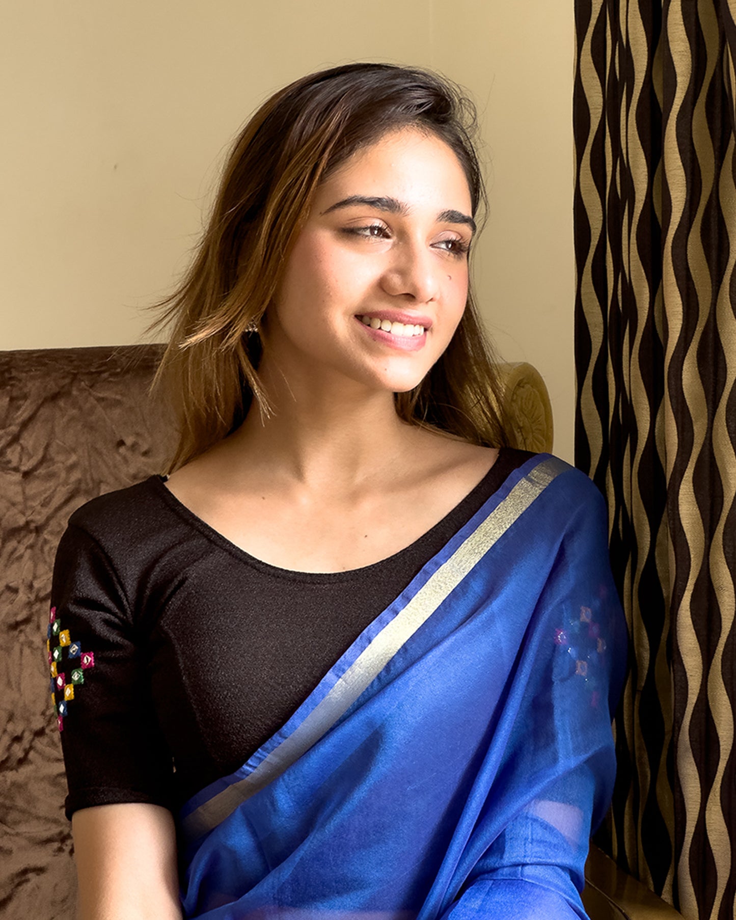 Model pairing the blouse with a saree, styled for festive occasions.