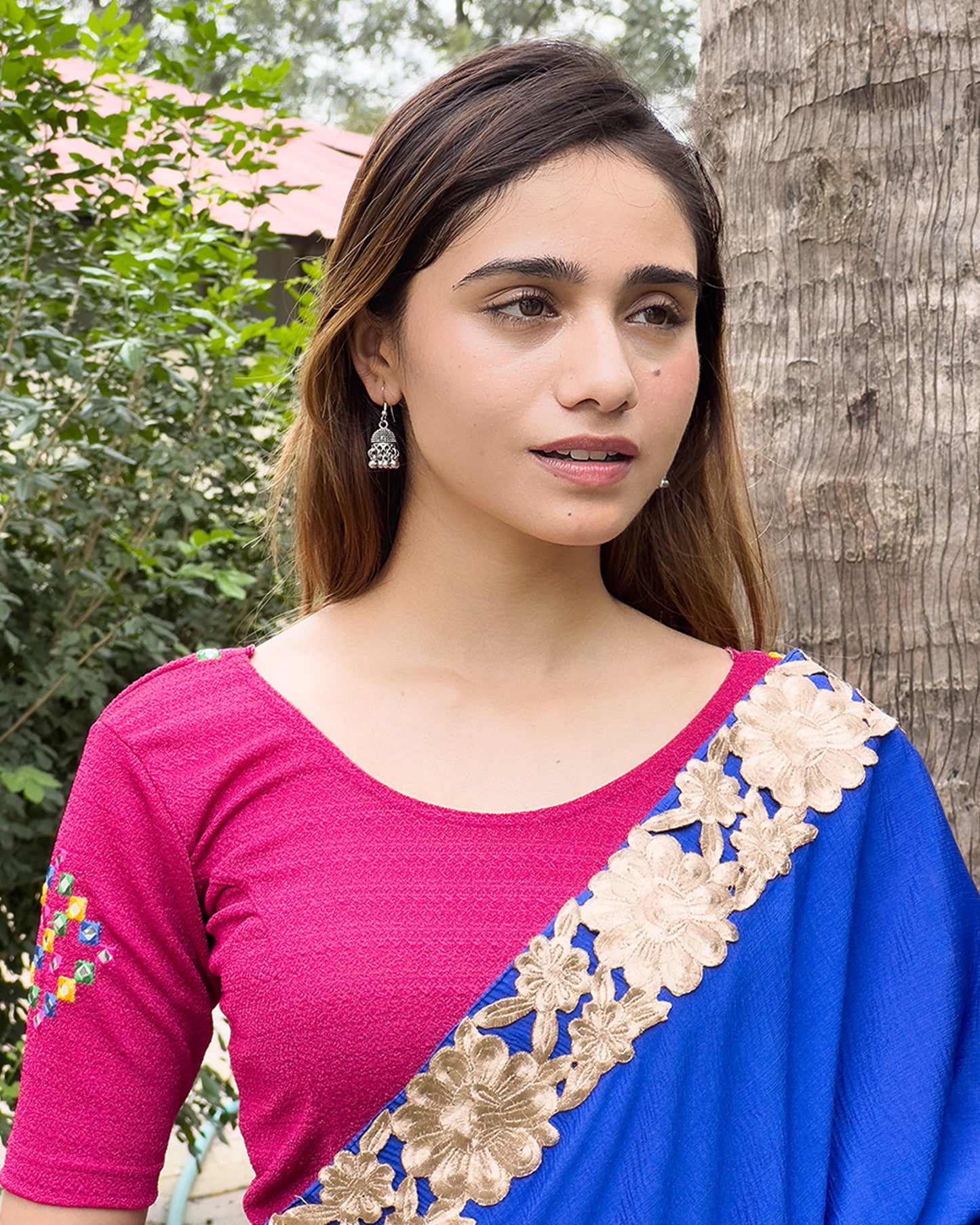 Model wearing a stretchable blouse with mirror embroidery on the neckline and sleeves.
