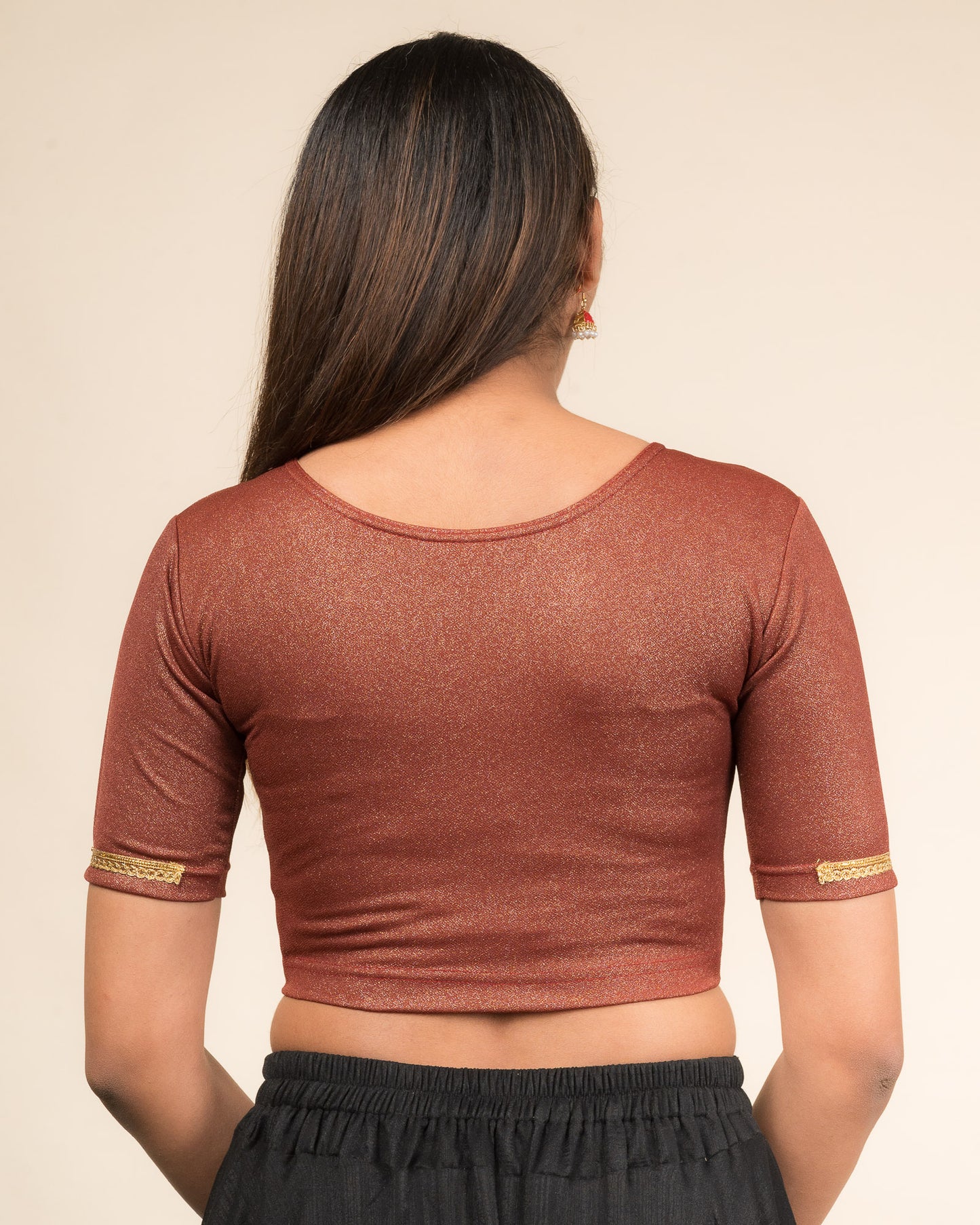 Rear view highlighting the blouse’s smooth back fit.