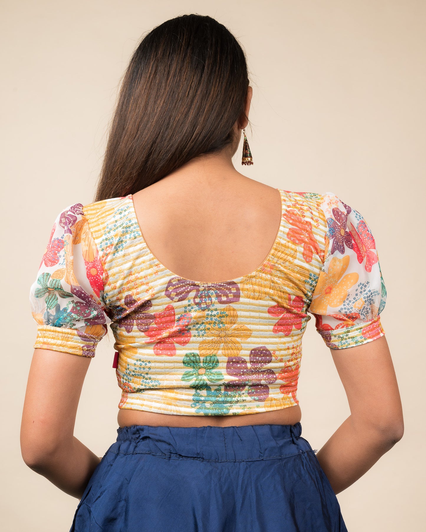 Rear view showing the blouse’s printed back and organza sleeves.