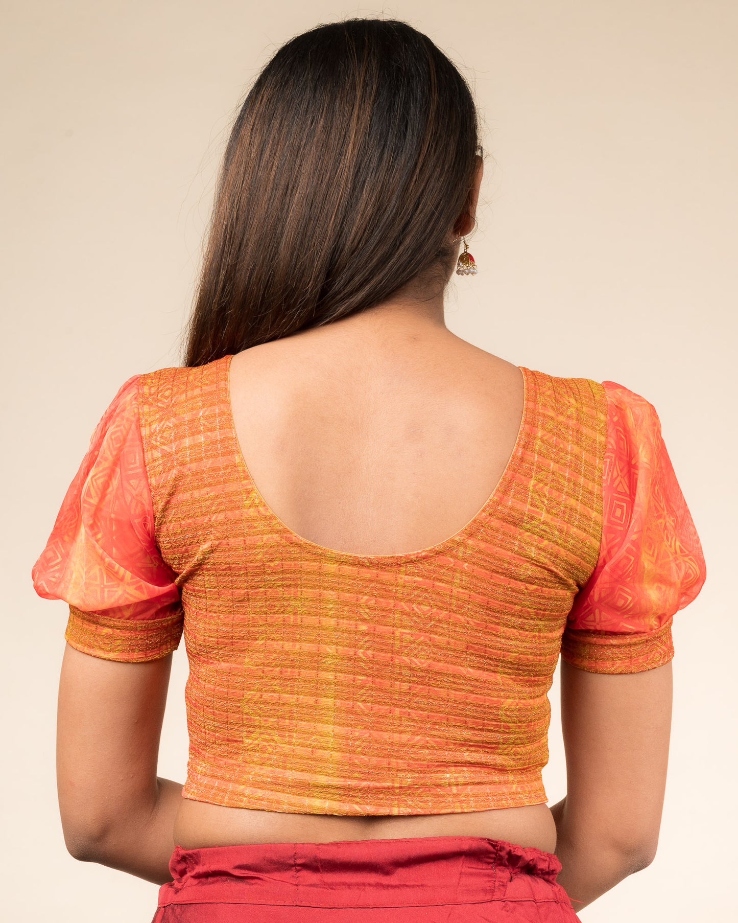 Rear view showing the blouse’s printed back and organza sleeves.