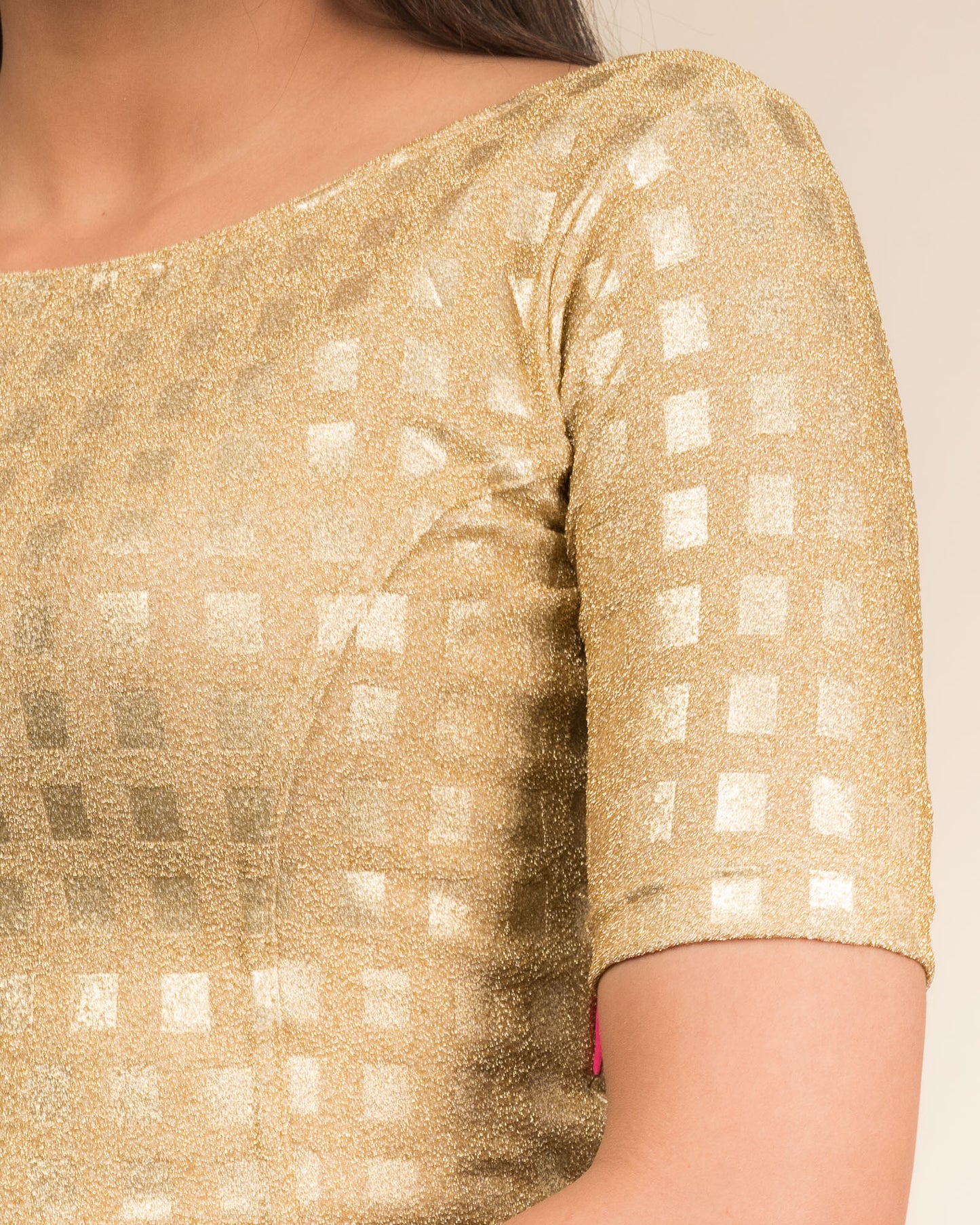Close-up of the jacquard texture with metallic check embossing.