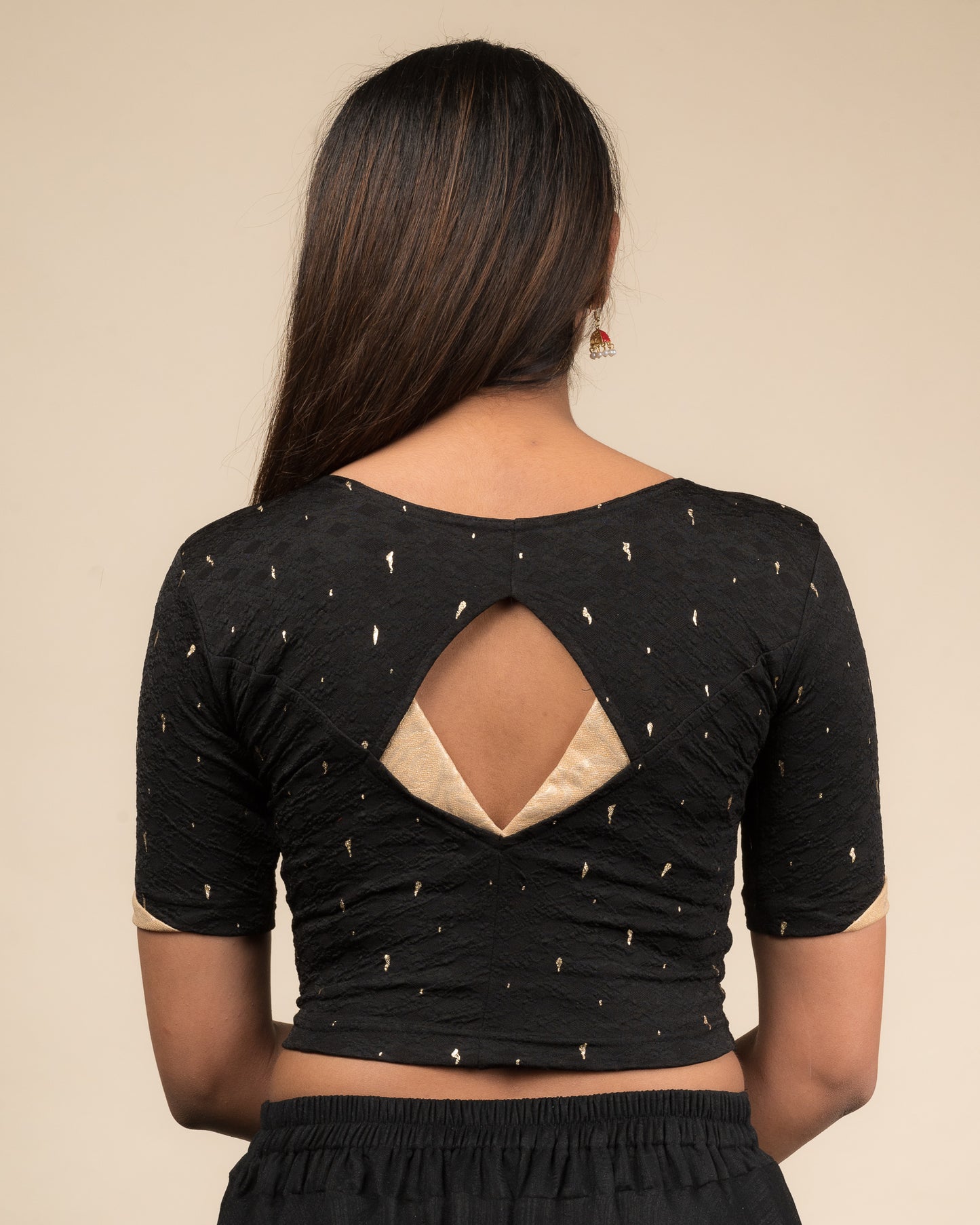 Rear view showcasing the artistically cut designer back design.