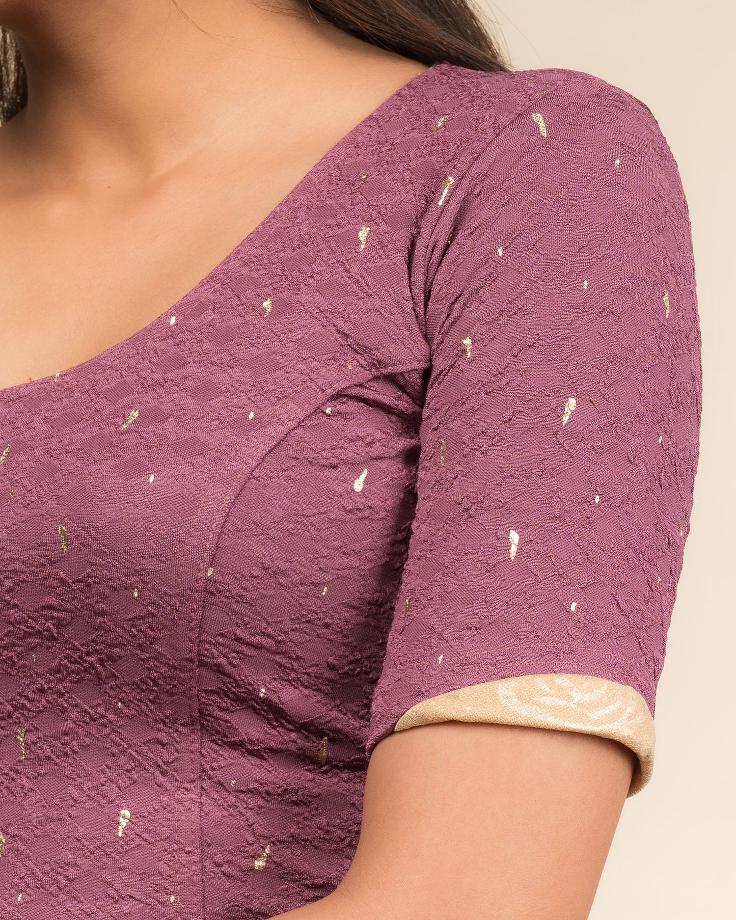 Close-up showing jacquard fabric with metallic drop accents.