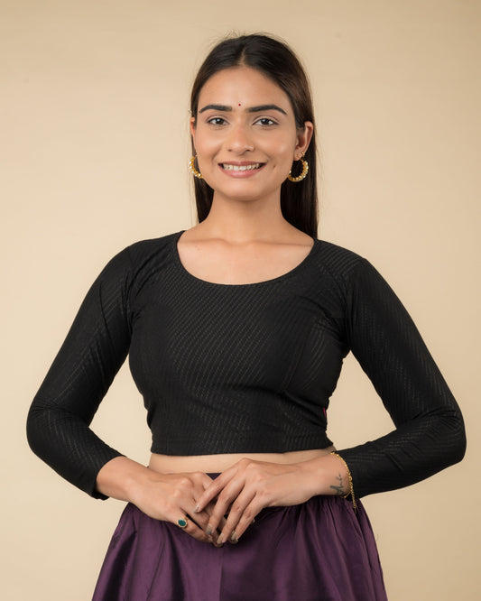 Model wearing a stretchable dobby-weave cotton blouse with long sleeves and round neckline