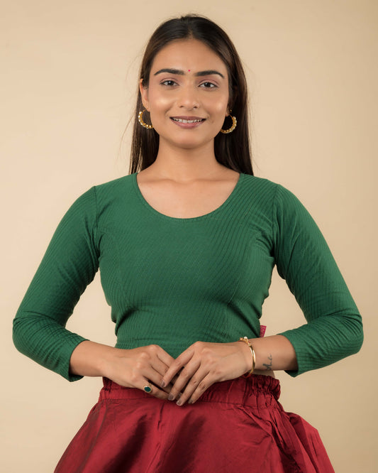 Model wearing a stretchable dobby-weave cotton blouse with long sleeves and round neckline