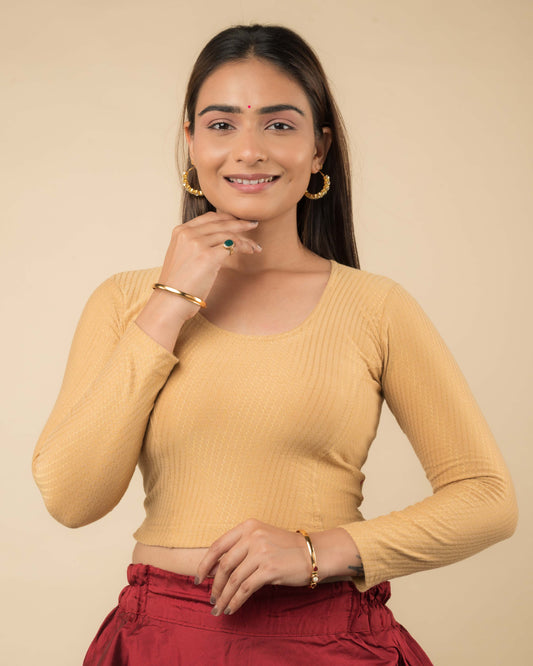 Model wearing a stretchable dobby-weave cotton blouse with long sleeves and round neckline
