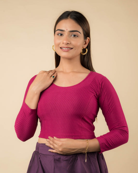 Model wearing a stretchable dobby-weave cotton blouse with long sleeves and round neckline