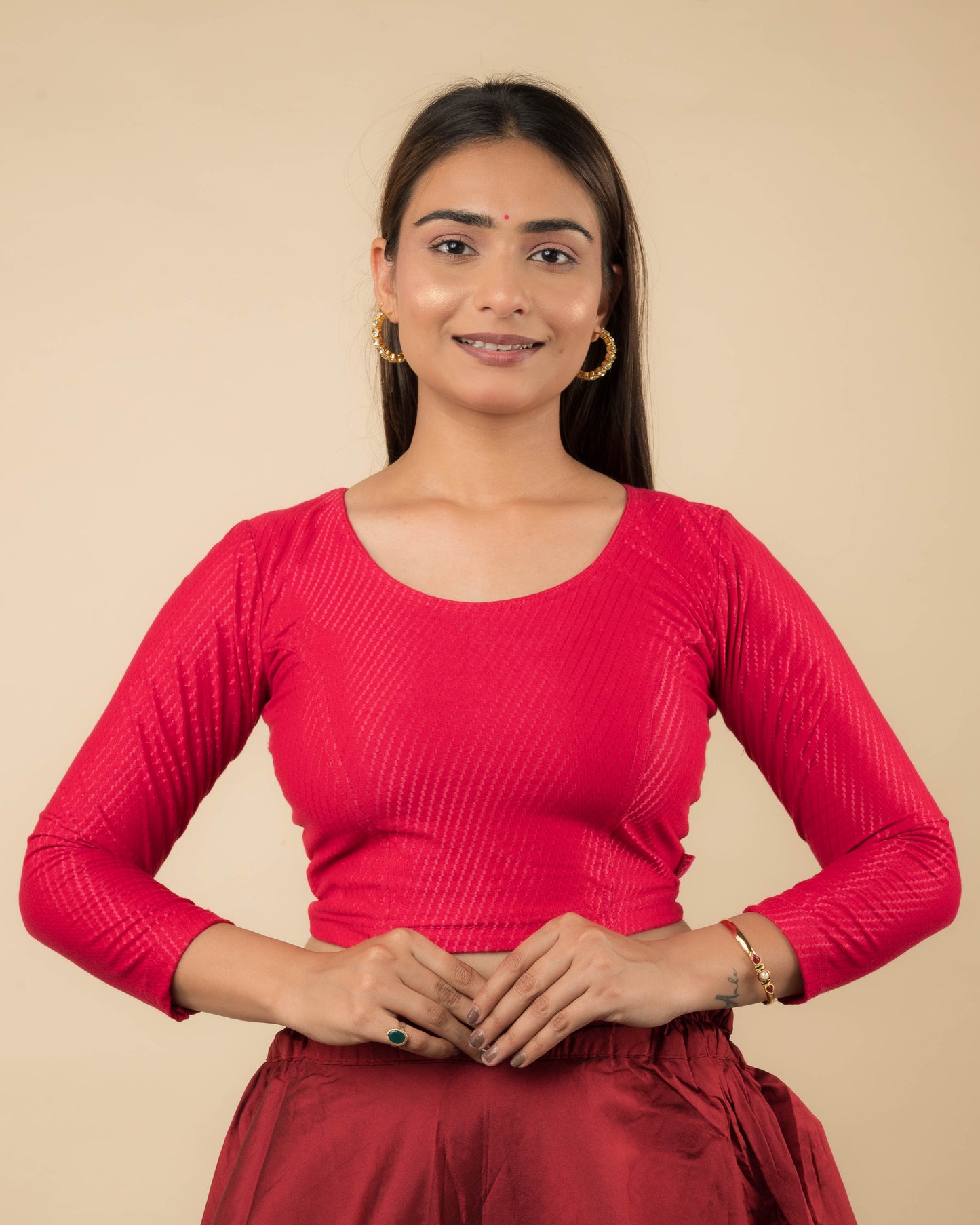 Model wearing a stretchable dobby-weave cotton blouse with long sleeves and round neckline