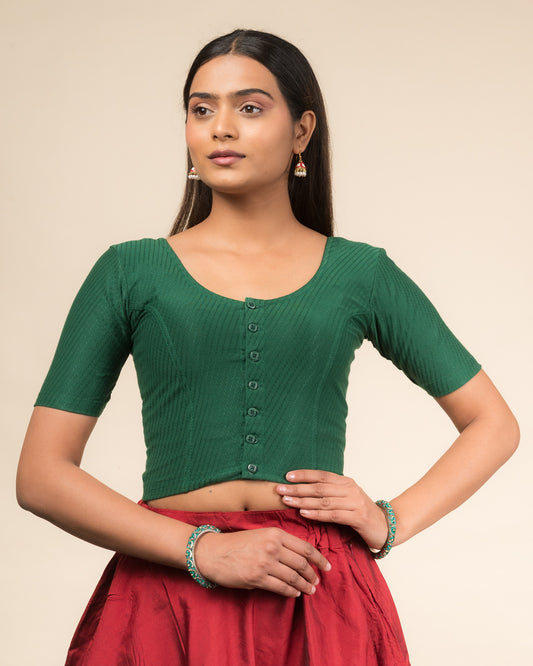Model wearing a stretchable dobby-weave cotton blouse with elbow sleeves, round neckline, and front-button closure