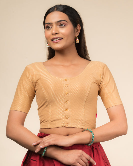Model wearing a stretchable dobby-weave cotton blouse with elbow sleeves, round neckline, and front-button closure