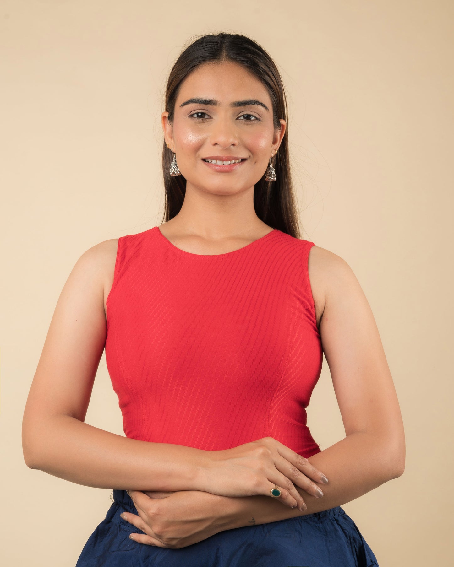 Model wearing a sleeveless stretchable cotton blouse with high neckline