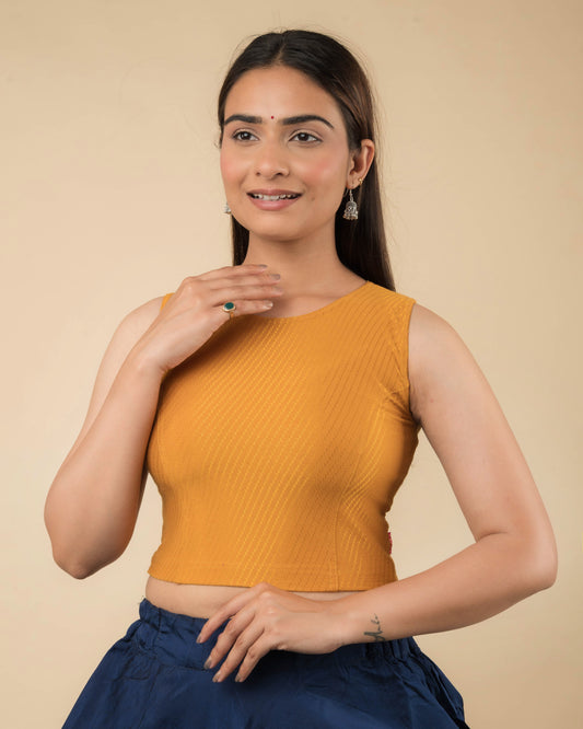 Model wearing a sleeveless stretchable cotton blouse with high neckline