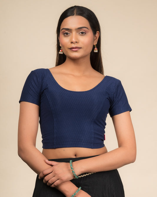  Model wearing a stretchable dobby cotton blouse with half sleeves and round neckline