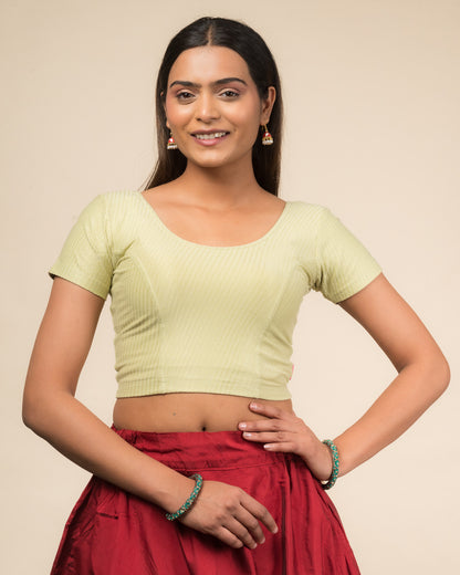  Model wearing a stretchable dobby cotton blouse with half sleeves and round neckline
