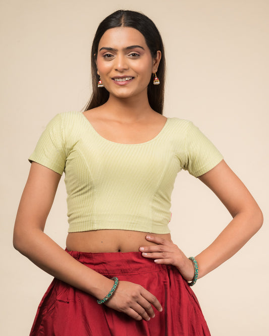  Model wearing a stretchable dobby cotton blouse with half sleeves and round neckline
