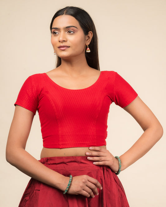  Model wearing a stretchable dobby cotton blouse with half sleeves and round neckline