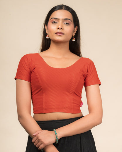 Model wearing a  stretchable dobby cotton blouse with half sleeves and round neckline