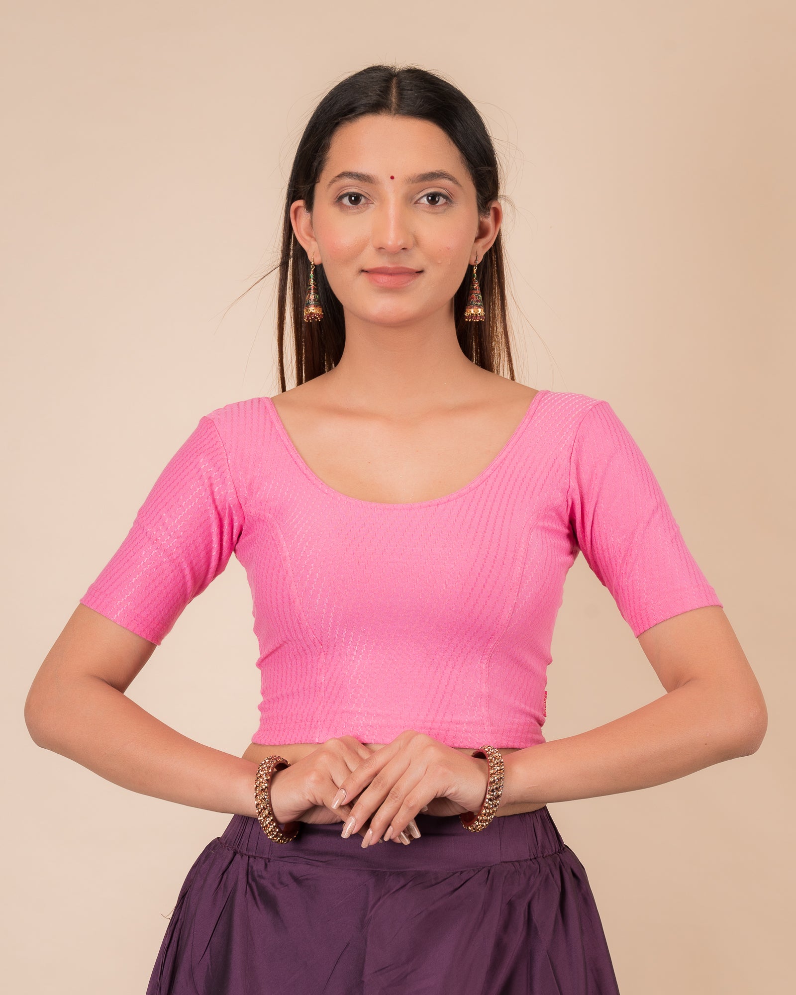 Model wearing a dobby cotton stretchable blouse with elbow sleeves and round neckline