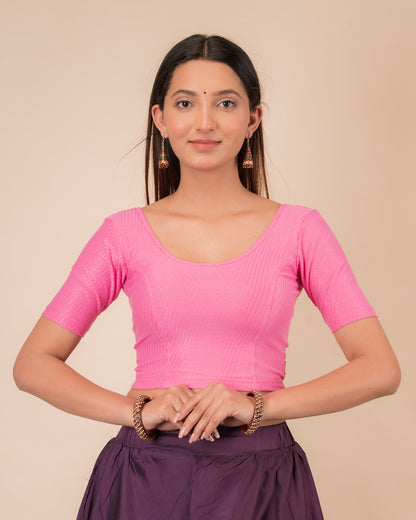 Model wearing a dobby cotton stretchable blouse with elbow sleeves and round neckline
