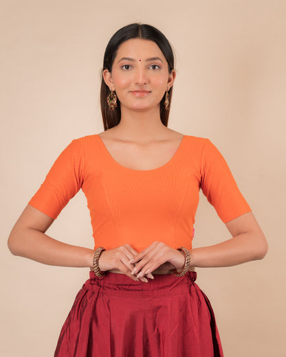 Model wearing a dobby cotton stretchable blouse with elbow sleeves and round neckline
