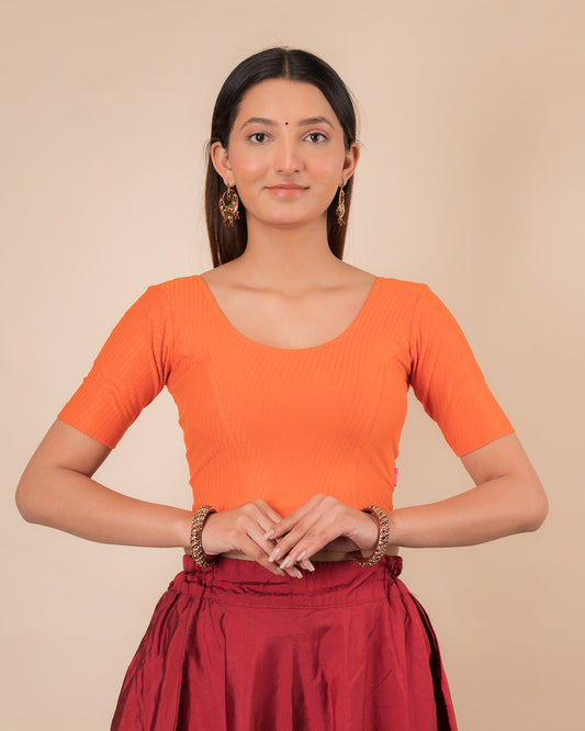 Model wearing a dobby cotton stretchable blouse with elbow sleeves and round neckline